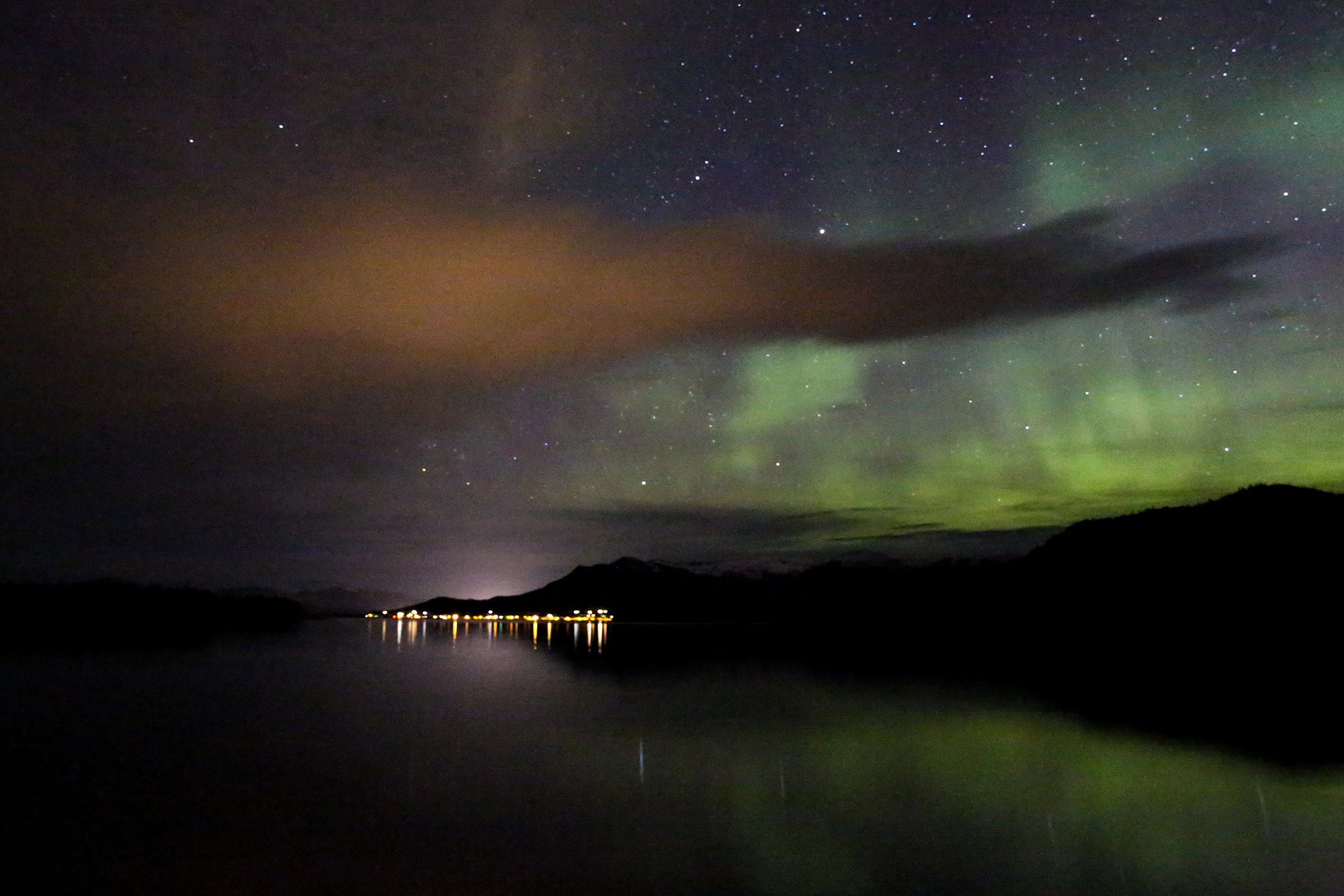 The Northern Lights shimmering over Ketchikan taken from a boat swinging at anchor